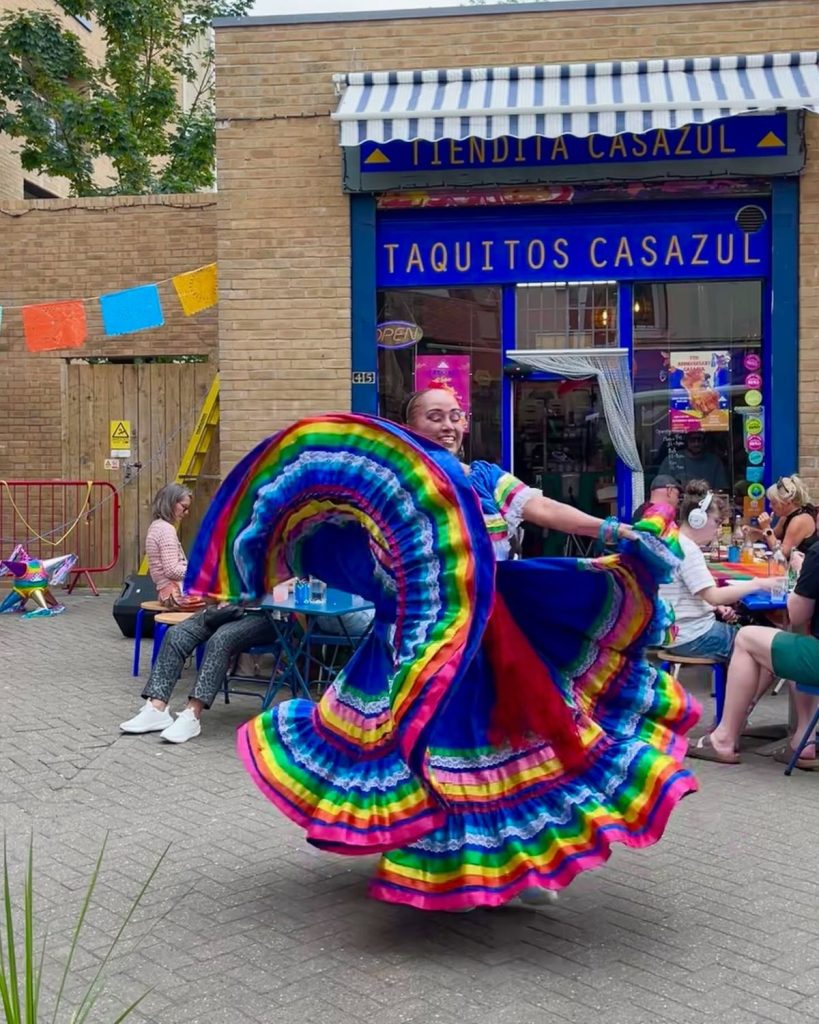 Dancer in a traditional Mexican skirt outside Taquitos Casazul